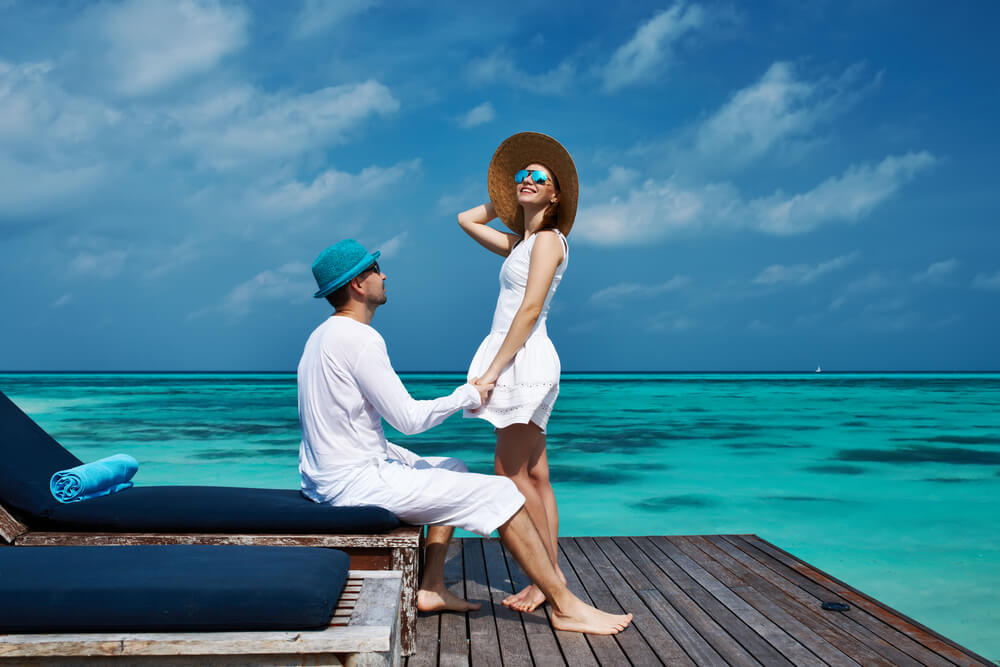 Couple on a Tropical Beach Jetty at Maldives
